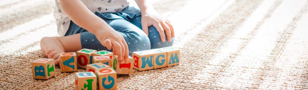 child playing with blocks - child and dependent care credit